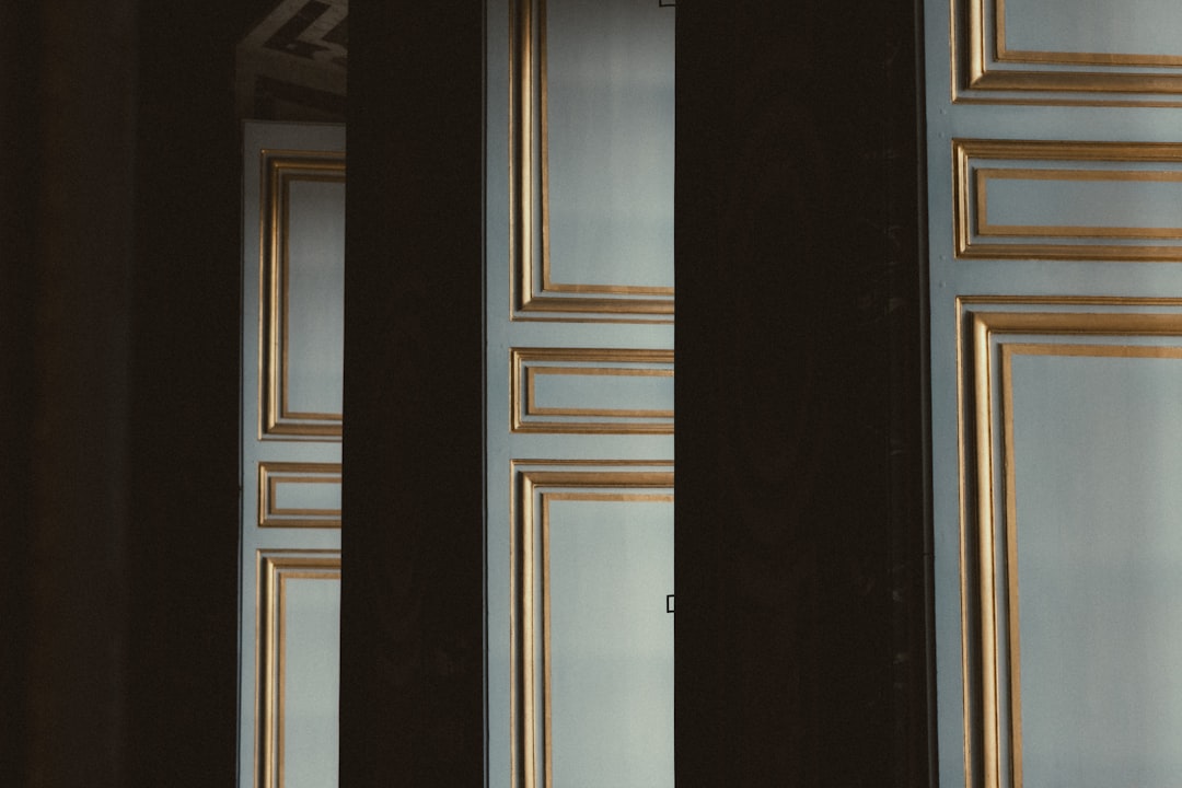 Elegant doors with gold trim are partially obscured.