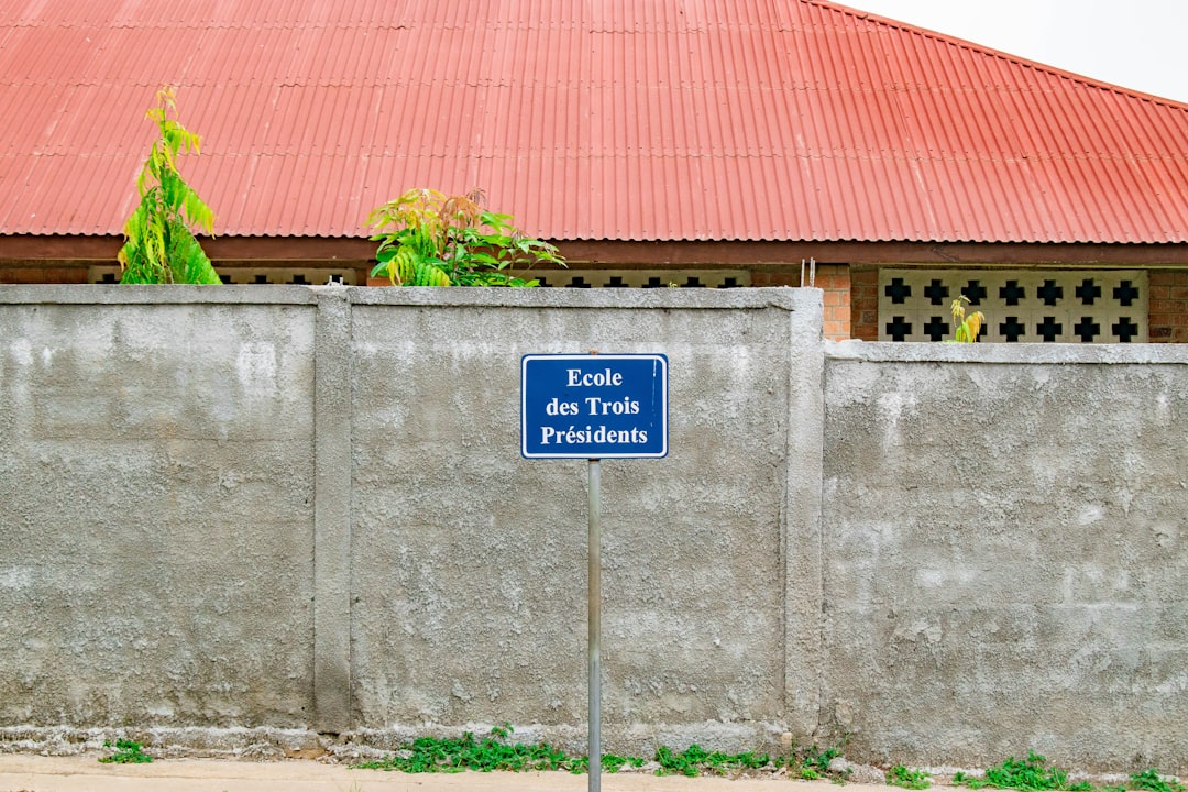 A blue and white sign sitting on the side of a road