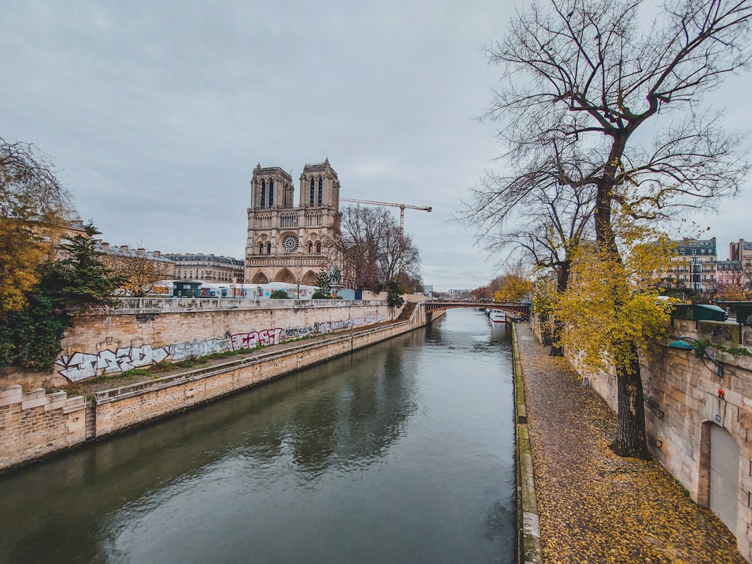 a river running through a city next to a tall building