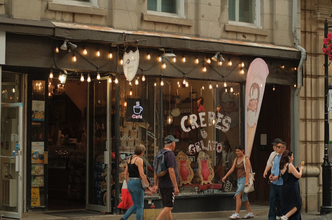 A group of people walking down a street in front of a store