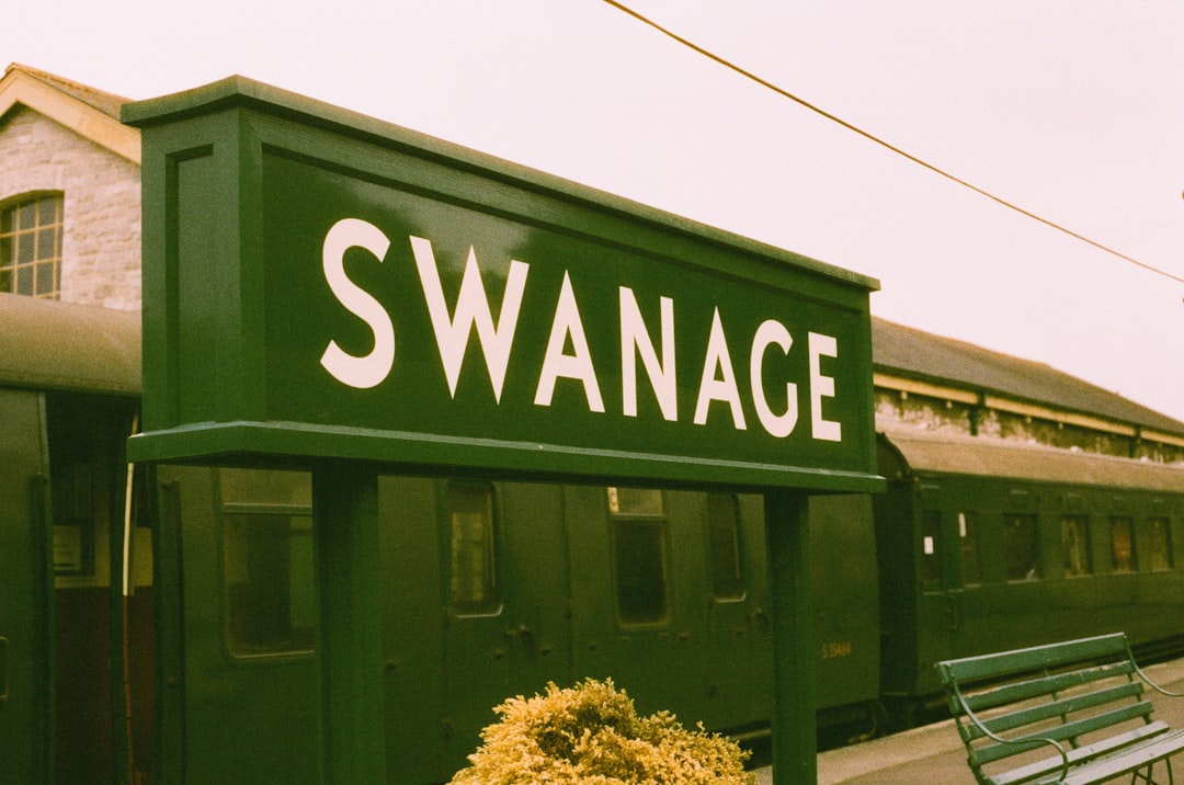 Green sign with swanage written in white
