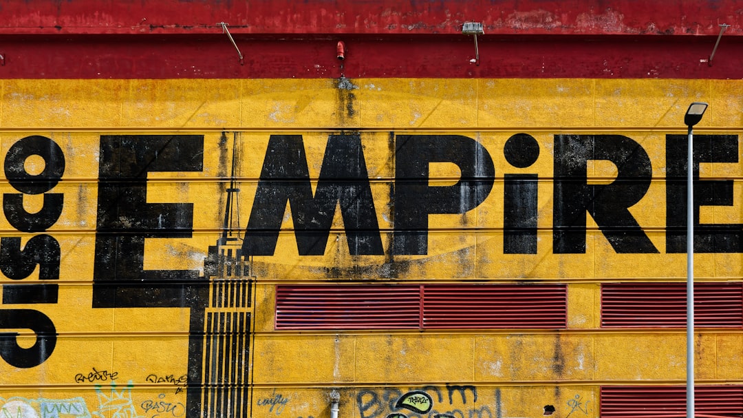 A yellow and red building with graffiti on it